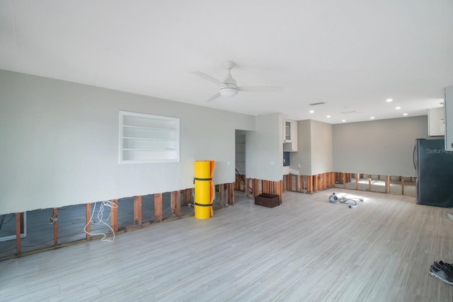 interior space featuring light hardwood / wood-style floors, built in features, and ceiling fan