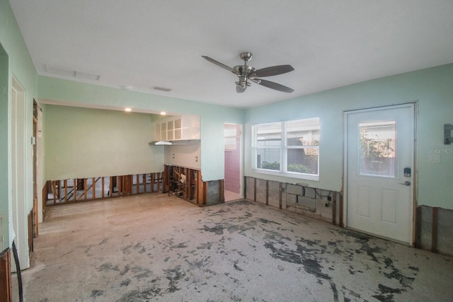 unfurnished living room with ceiling fan