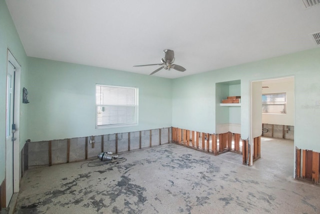 spare room featuring ceiling fan and concrete flooring