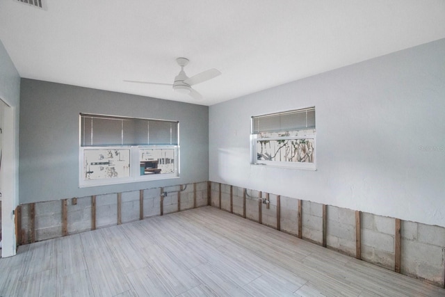 empty room featuring ceiling fan and light hardwood / wood-style flooring