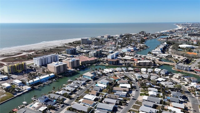 birds eye view of property featuring a water view and a beach view