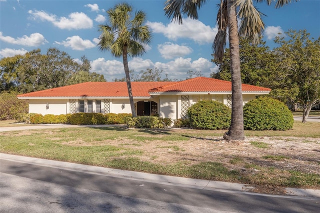 mediterranean / spanish-style house featuring a front lawn