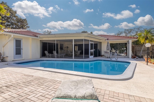 view of pool featuring a sunroom and a patio