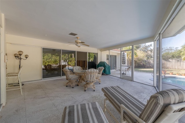 sunroom featuring ceiling fan