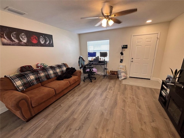 living room with ceiling fan and light wood-type flooring