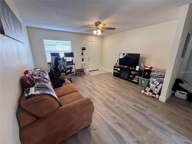 living room featuring ceiling fan and wood-type flooring