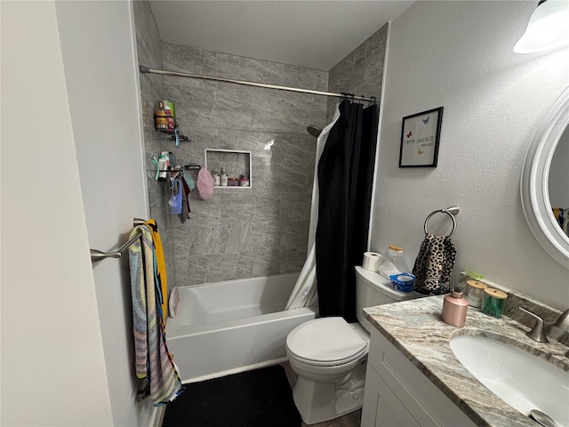 full bathroom with vanity, shower / bath combo, and toilet