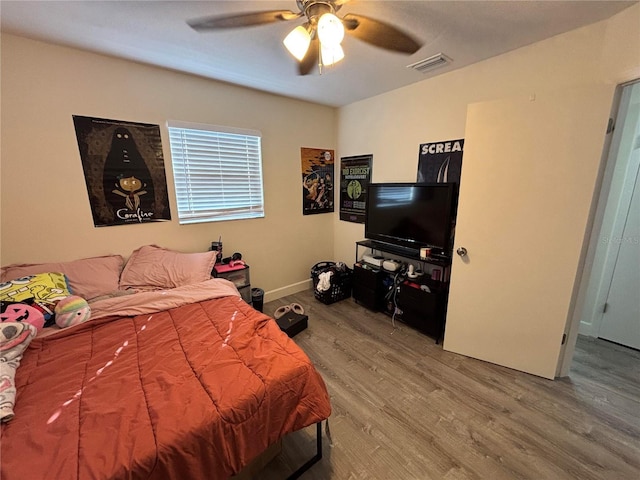 bedroom featuring ceiling fan and hardwood / wood-style flooring