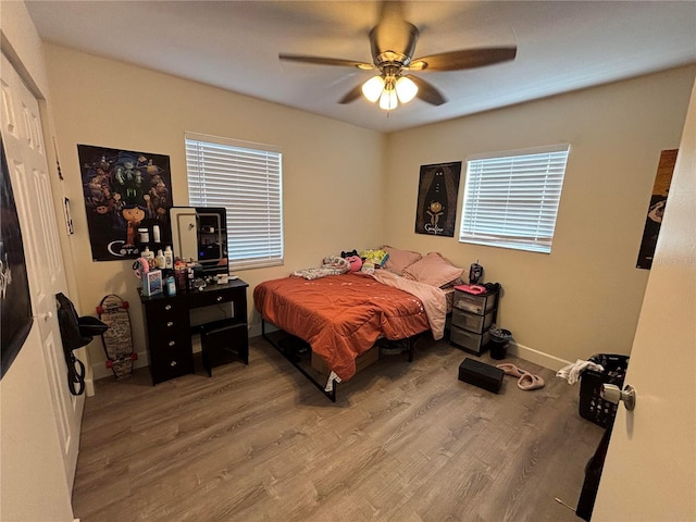 bedroom with ceiling fan and wood-type flooring