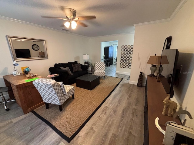 living room with hardwood / wood-style flooring, ceiling fan, crown molding, and a textured ceiling