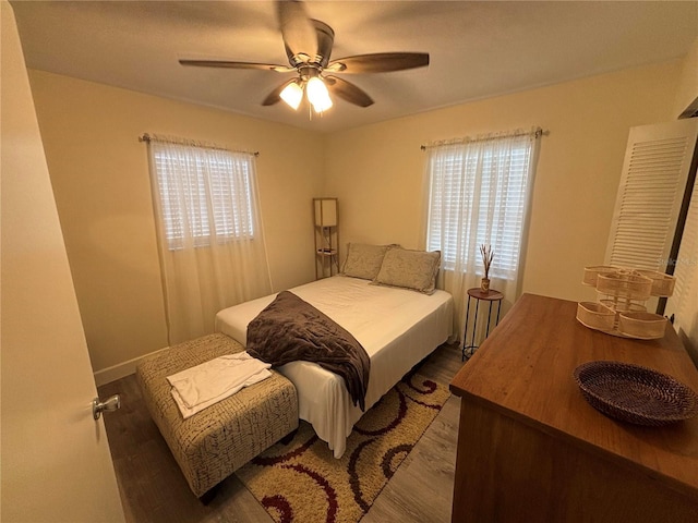 bedroom with ceiling fan and dark hardwood / wood-style floors