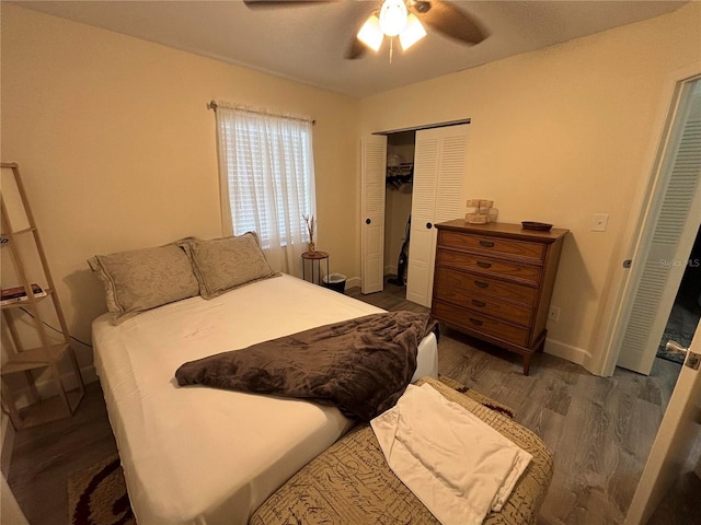 bedroom with ceiling fan, a closet, and dark hardwood / wood-style floors