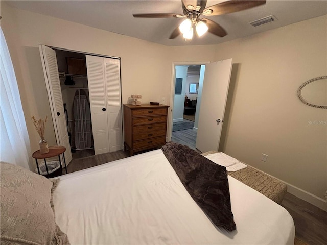 bedroom with ceiling fan, dark hardwood / wood-style floors, and a closet