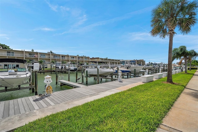 dock area featuring a lawn and a water view