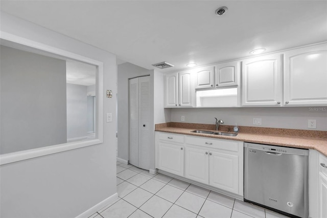 kitchen featuring dishwasher, light tile patterned flooring, white cabinetry, and sink