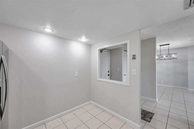 unfurnished room featuring light tile patterned flooring