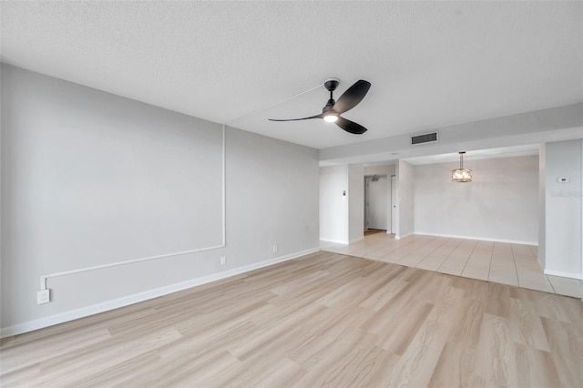 interior space featuring ceiling fan, light hardwood / wood-style flooring, and a textured ceiling