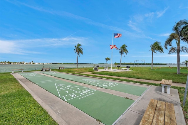 view of community featuring a yard and a water view