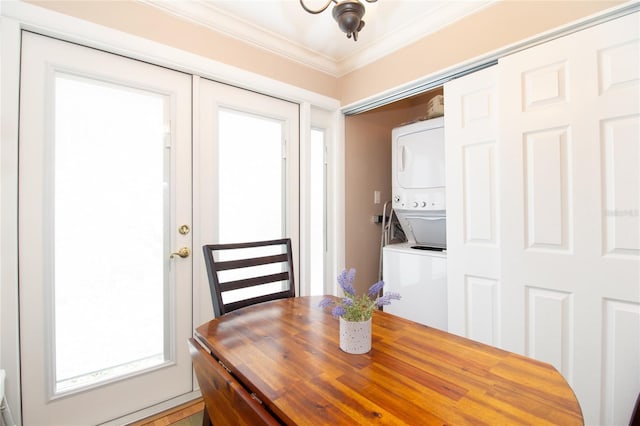 dining room with stacked washer and dryer and crown molding