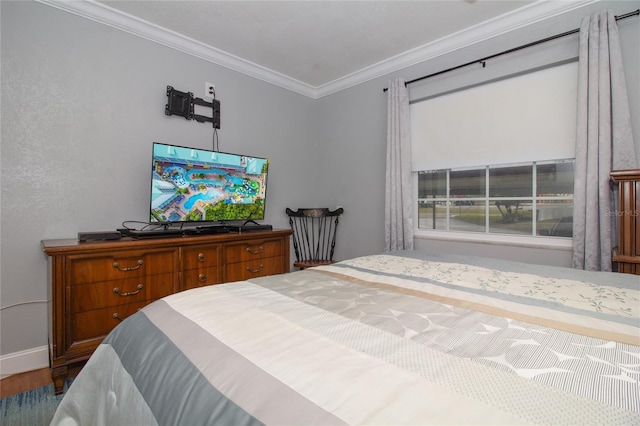 bedroom with ornamental molding and wood-type flooring