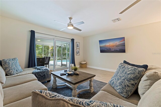 living room with ceiling fan and wood-type flooring