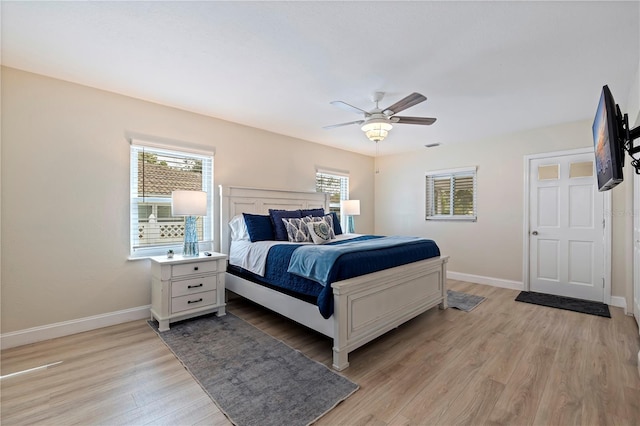 bedroom with ceiling fan and light hardwood / wood-style floors