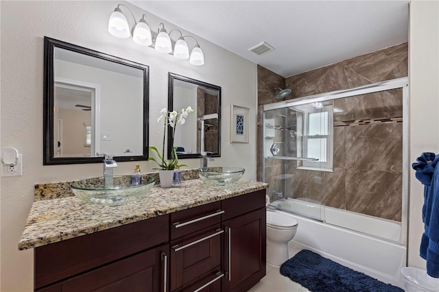 full bathroom featuring toilet, tile patterned flooring, vanity, and shower / bath combination with glass door