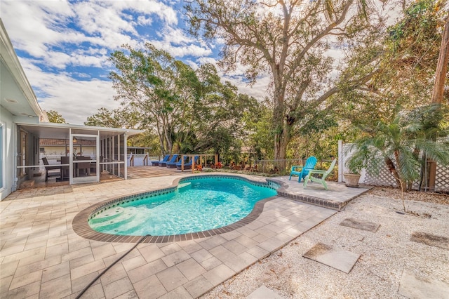 view of pool with a patio area and a sunroom