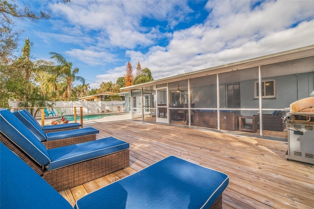 deck with area for grilling and a sunroom