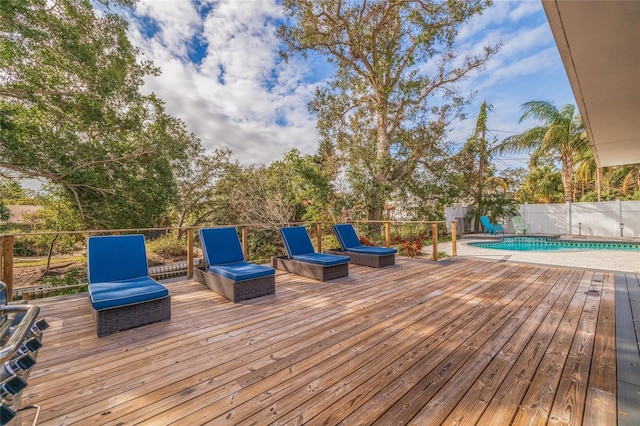 wooden terrace featuring a fenced in pool