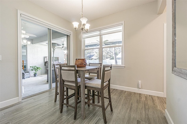 dining room featuring hardwood / wood-style floors and an inviting chandelier