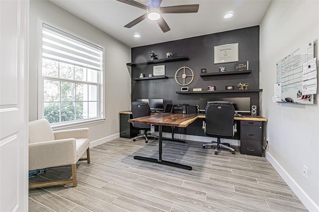 home office with ceiling fan and light hardwood / wood-style flooring