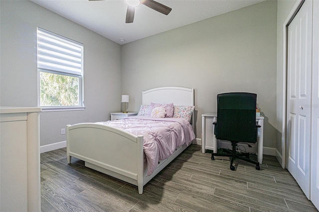 bedroom with ceiling fan, wood-type flooring, and a closet