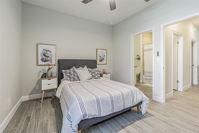 bedroom featuring connected bathroom, ceiling fan, and light hardwood / wood-style floors