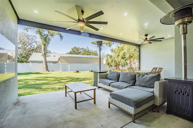 view of patio / terrace with ceiling fan and an outdoor living space