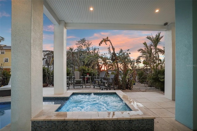 view of pool with an in ground hot tub and a patio area