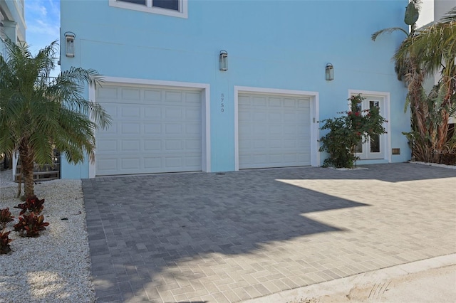 garage featuring decorative driveway