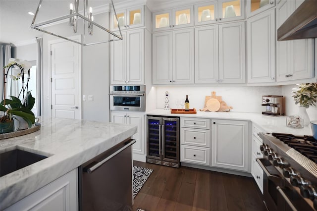 kitchen with under cabinet range hood, white cabinets, beverage cooler, and appliances with stainless steel finishes