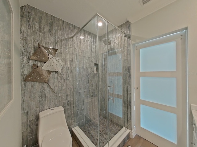 full bathroom with tile walls, toilet, visible vents, and a stall shower