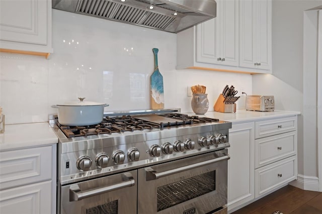 kitchen with premium range hood, double oven range, white cabinets, and light countertops