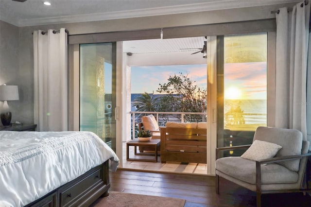 bedroom featuring multiple windows, crown molding, and hardwood / wood-style flooring