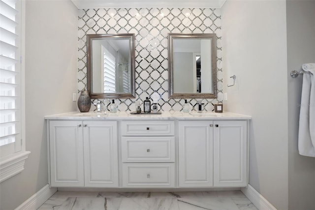 full bathroom with baseboards, marble finish floor, and a sink