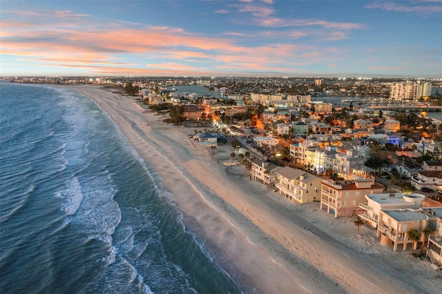 drone / aerial view featuring a city view, a beach view, and a water view