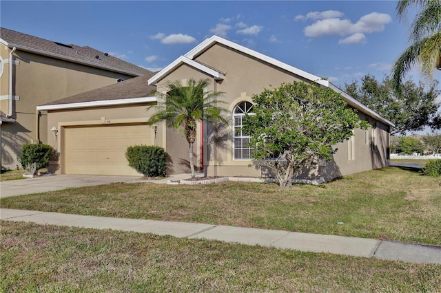 view of front of property with a front yard and a garage