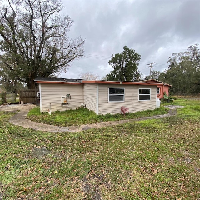 view of side of home featuring a lawn