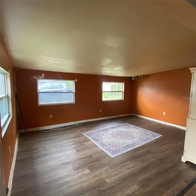 empty room with dark wood-type flooring