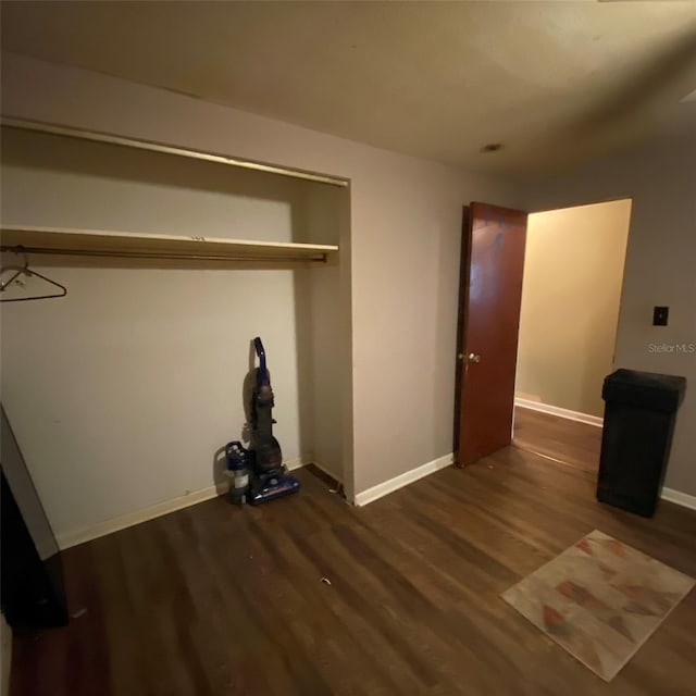 unfurnished bedroom with dark wood-type flooring