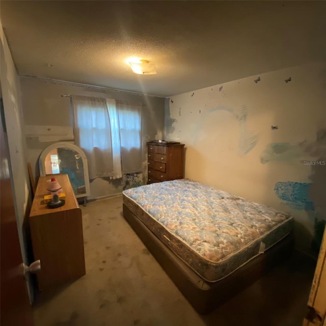 bedroom with carpet flooring and a textured ceiling