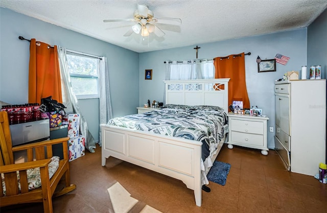 bedroom with ceiling fan and a textured ceiling