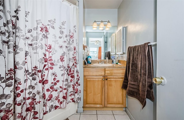 bathroom featuring tile patterned flooring, vanity, shower / bathtub combination with curtain, and ceiling fan